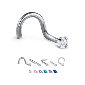 May include: A silver nose ring with a clear gemstone. The ring is curved and has a small, round gemstone at the end. The ring is shown with other nose rings with different coloured gemstones.