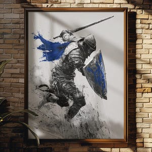 May include: Framed artwork depicting a knight in action, wielding a sword and shield. The knight is rendered in shades of gray and black with splashes of blue. The artwork is displayed on a brick wall.