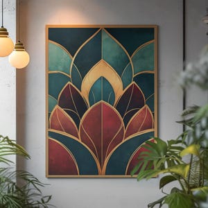 May include: A framed art print featuring an abstract floral design. The artwork showcases a symmetrical arrangement of teal, burgundy, and gold leaf shapes. The print is displayed on a neutral-colored wall, with plants in the foreground.