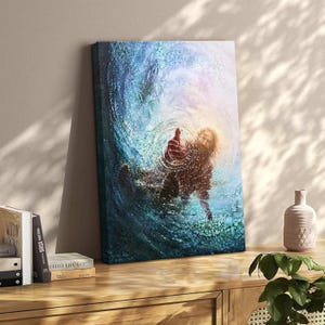 May include: Canvas art print showing a person reaching out from swirling blue water. The artwork uses blues, greens, and yellow, creating a dynamic, textured effect. The person's hand is outstretched, suggesting a theme of hope or rescue. The canvas is 60 cm x 40 cm.