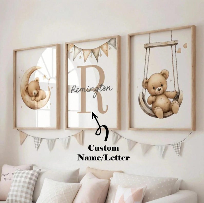 May include: Three framed nursery art prints featuring a teddy bear theme. One print shows a bear on a crescent moon, another displays the letter "R" with the name "Remington", and the third shows a bear on a swing. The prints are in neutral tones.