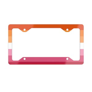 May include: A rectangular license plate frame featuring a horizontal gradient pattern. The colors transition from a deep orange at the top, through lighter orange and white in the center, to shades of pink and dark magenta at the bottom edge.
