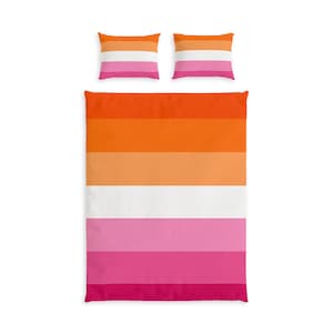 May include: A bedding set consisting of a large rectangular duvet cover and two matching rectangular pillowcases. The fabric features horizontal stripes in a gradient of colours, transitioning from dark orange to light orange, white, light pink, and dark pink.