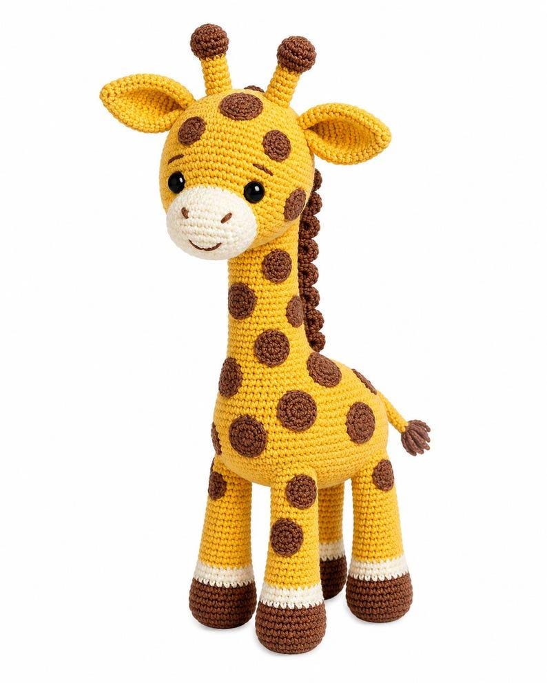 Op de afbeelding: Een gehaakt giraffespeeltje met een geel lichaam met bruine vlekken, een cr&egrave;mekleurige snuit en donkerbruine hoeven. De giraffe heeft twee kleine hoorntjes op het hoofd, grote zwarte ogen, een geborduurde glimlach en donkerbruine manen op de nek.