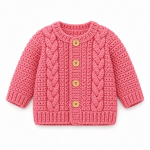 May include: A long-sleeved, hot pink cardigan featuring a textured cable knit pattern on the front panels. The garment has a round neckline, ribbed cuffs and hem, and is fastened down the centre with four light brown, circular wooden buttons.