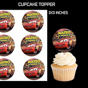 May include: Cupcake toppers featuring a red race car with the text "MATEO IS TURNING 2". The toppers are 3x3 inches in size. A cupcake with white frosting is also shown.