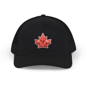 May include: Black trucker hat with a red and orange maple leaf design. The hat features a mesh back and a curved brim. The maple leaf is a geometric design with a white outline.