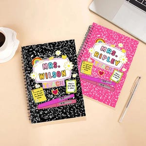 May include: Two spiral-bound notebooks with teacher-themed designs. One notebook has a black and white speckled cover with "Mrs. Wilson" and "Teach" text. The other notebook has a pink speckled cover with "Mrs. Ripley" and "Teach" text. Both notebooks have flower and rainbow accents.