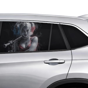 May include: A silver car window featuring a graphic of a woman with pigtails, holding a baseball bat. The woman is wearing a red top and has blue and red hair. The background is dark with smoky effects.