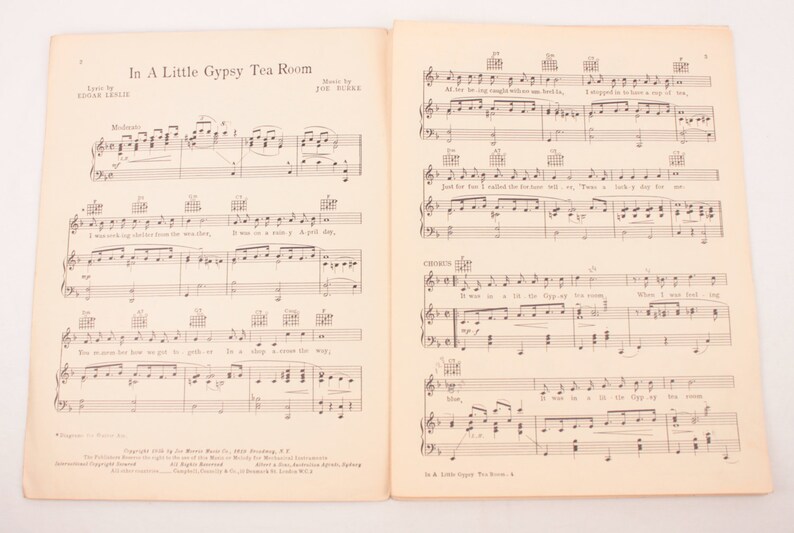 May include: A vintage sheet music score for the song "In A Little Gypsy Tea Room" by Edgar Leslie and Joe Burke. The sheet music features the lyrics and musical notation for the song.