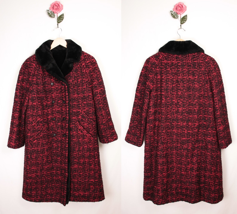 May include: A long red and black tweed coat with a black faux fur collar. The coat has a double breasted closure and two pockets.