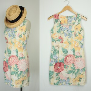 May include: A sleeveless floral print dress with a square neckline and a zipper closure in the back. The dress is made of a light-weight fabric and has a fitted silhouette.