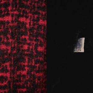 May include: Red and black tweed fabric with a white label that says "The Woolmark Company" in blue lettering.