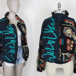 May include: A black and teal jacket with a colorful geometric pattern. The jacket has a zipper closure and a stand-up collar.