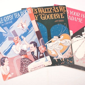 May include: Three vintage sheet music covers with colorful illustrations. The covers feature the titles "In a Little Gypsy Tearoom", "Thus Waltzas We Say Goodbye", and "Kiss Your Hand, Madame".