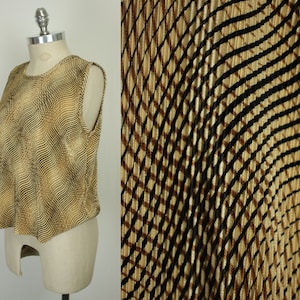 May include: A sleeveless top with a brown and gold abstract pattern. The fabric has a subtle sheen and a slightly textured surface.