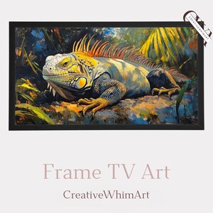 May include: A framed artwork featuring a detailed painting of an iguana. The reptile is depicted with yellow, orange, and blue hues, set against a backdrop of lush foliage. The artwork is framed in a black border. The text "Frame TV Art" and "CreativeWhimArt" are displayed below.