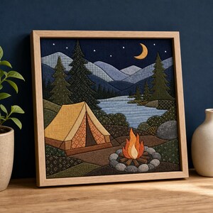 May include: A square fabric wall art piece in a light wood frame depicting a night camping scene. It features a yellow tent, a campfire surrounded by stones, a blue lake, dark green pine trees, layered mountains, and a yellow crescent moon.
