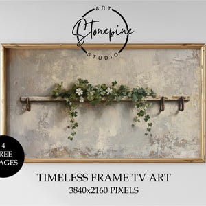 May include: A rectangular framed artwork with a gold border. The image shows a distressed, textured background with a wooden shelf decorated with greenery and white flowers. The text "Stonepine Studio" is at the top.