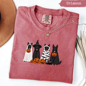 Crimson Comfort Colors t-shirt with four dogs in Halloween costumes and pumpkins.