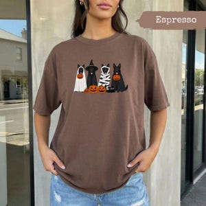 Brown t-shirt with German Shepherds in Halloween costumes and pumpkins.