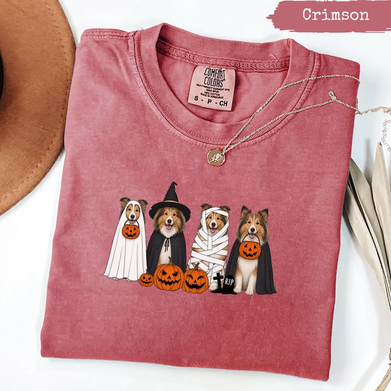 Crimson Comfort Colors shirt featuring four dogs in Halloween costumes.