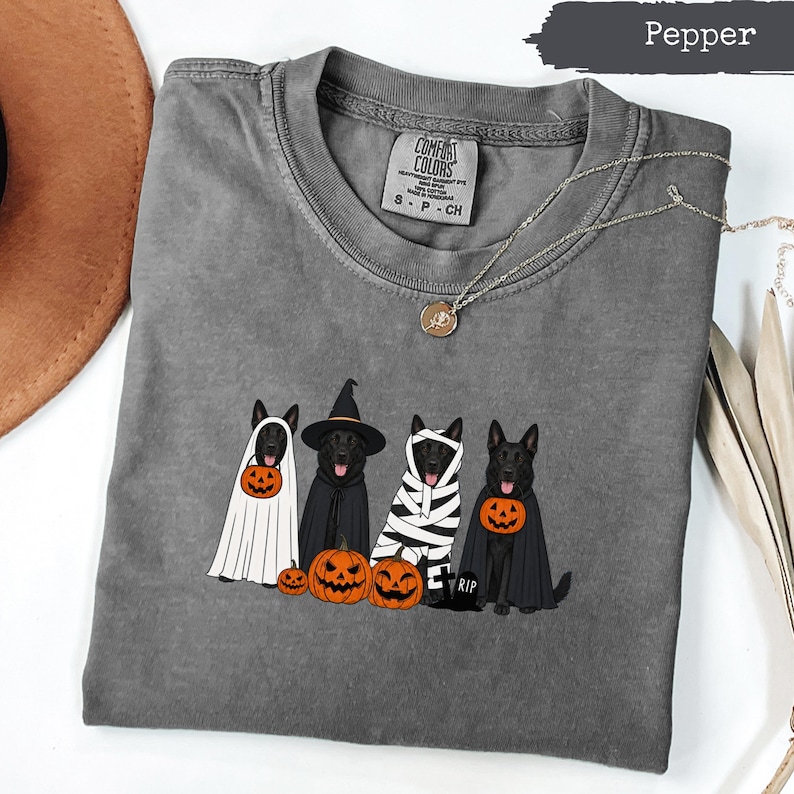 Dark grey t-shirt with graphic of dogs dressed as ghosts, witch, and mummy, with pumpkins.