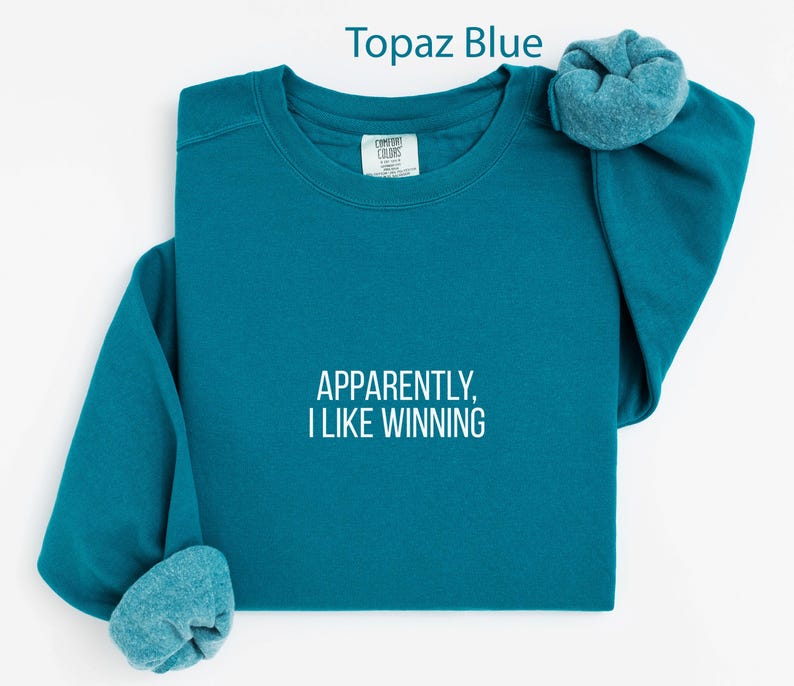 Apparently I Like Winning Topaz Blue Sweatshirt, Motivational Quote Shirt, Inspirational Graphic Tee, Uplifting Casual Wear, Cozy Pullover