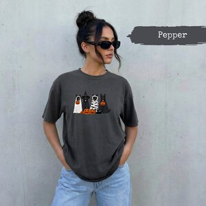 Dark grey t-shirt with Halloween dog graphic and "Pepper" text on muted background.