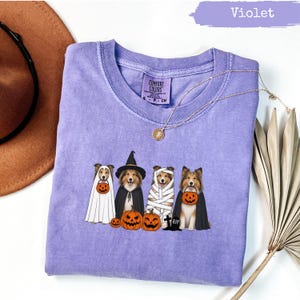 Violet t-shirt with four dogs dressed for Halloween.