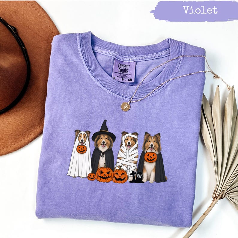 Violet t-shirt with four dogs dressed for Halloween.
