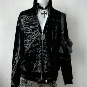 Zip Up Jacket | Gothic High Neck Sweater | Daily Wear | Y2K Streetwear Style

Zip up jacket with skeleton graphic print, gothic high neck design, and Y2K streetwear aesthetic.