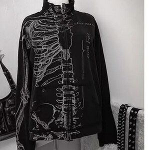 Zip Up Jacket | Gothic High Neck Sweater | Daily Wear | Y2K Streetwear Style

Zip up jacket with skeleton graphic print, gothic high neck design, and Y2K streetwear aesthetic.