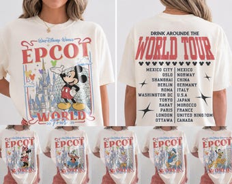 May include: An off-white t-shirt featuring a front graphic of Mickey Mouse, the Epcot castle, and the text 'Epcot World Tour 26'. The back displays the text 'Drink Arounde The World Tour' with a list of cities and countries including Mexico, Norway, China, Germany, Italy, U.S.A, Japan, Morocco, France, United Kingdom, and Canada.