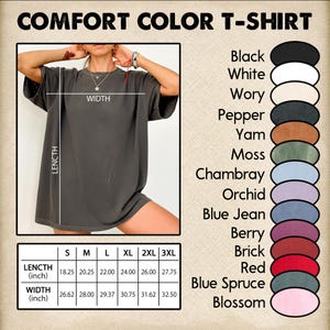 May include: A Comfort Color T-shirt in a dark grey colour is shown, with measurements in inches. The image includes a colour chart with options like black, white, and red. The shirt's length ranges from 46.36 to 70.49 cm.