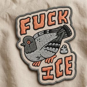 May include: Embroidered patch featuring a gray pigeon with orange feet and eye. The patch has the words "FUCK ICE" in orange letters. The patch is outlined in gray and has a beige background.