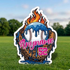 May include: A baseball-themed yard sign featuring a baseball in a mitt, with flames and dripping blue accents. The sign includes the text "Anyname" and the number "52" in pink.