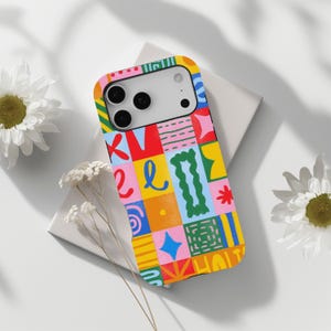 May include: A smartphone case featuring a vibrant grid pattern of colourful squares. Each square contains distinct hand-drawn elements including red, blue, yellow, pink, and green shapes, squiggles, dots, and lines, creating a playful, multi-coloured design.