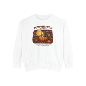 May include: A white long-sleeve sweatshirt featuring a graphic of a tabby cat sitting on a pumpkin in a field under a full moon. The text reads PUMPKIN PATCH SUPERVISOR, ALL PUMPKINS INSPECTED, ALL PUMPKINS MINE in brown and black lettering.