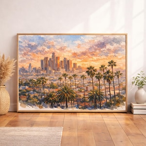May include: A rectangular framed wall art print featuring a watercolor painting of the Los Angeles skyline at sunset. The scene depicts tall city skyscrapers in the distance, surrounded by numerous palm trees and residential buildings under a vibrant orange, pink, and blue sky.