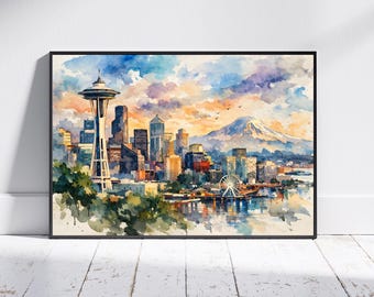 May include: A framed watercolor painting of the Seattle skyline featuring the Space Needle, a Ferris wheel, and a snow-capped mountain in the background under a vibrant sunset sky with orange, purple, and blue clouds reflected in the water.