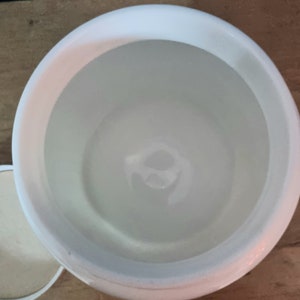 May include: White ceramic jar with a lid. The jar is empty and has a smooth, glossy finish.