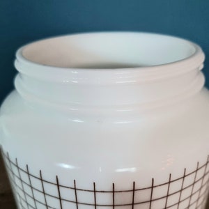 May include: White ceramic jar with a brown grid pattern and the word "Flour" printed on the front.