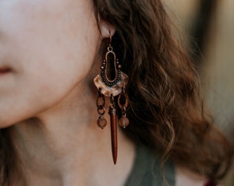 murielle. a pair of tribal-esque inspired copper earrings with sea glass beads and brown howlite spikes.