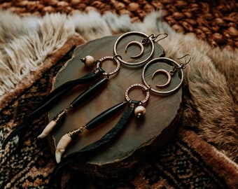 lilith. a pair of mixed metal earrings with copper moons and black deerskin leather.