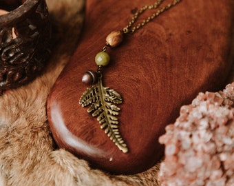 forest dweller. an earthy bohemian fern necklace adorned with a copper acorn and earth tone beads.