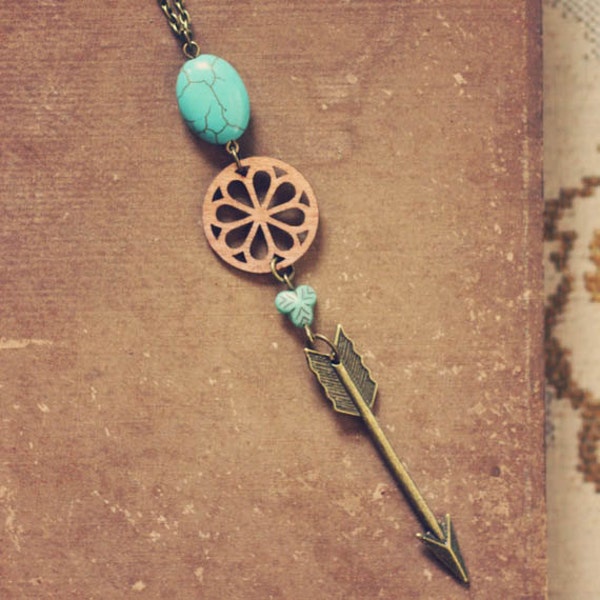 baswell.  a long turquoise wood and arrow necklace.