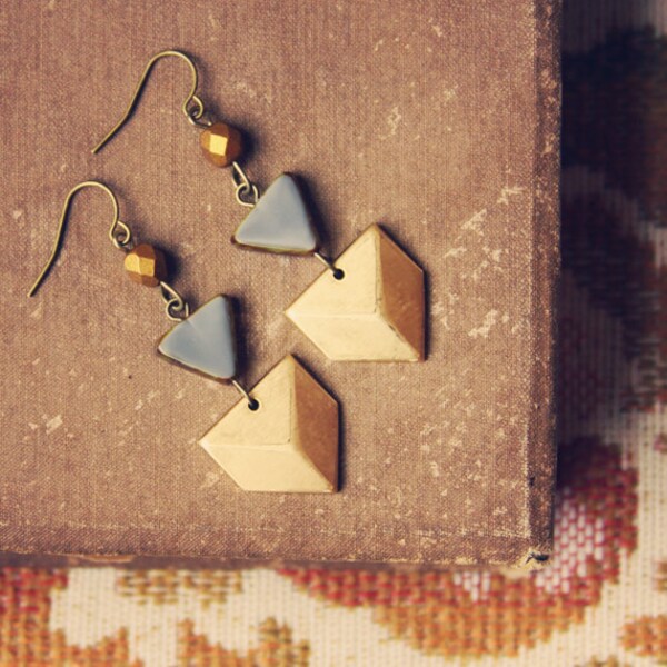 nova.  a pair of gold and grey geometric chevron earrings.