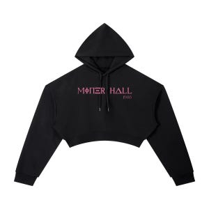 May include: Black cropped hoodie with a drawstring hood and long sleeves. The front features the text "MOTHER HALL" in pink, with "1908" below it. The hoodie has a relaxed fit and a cropped hemline.