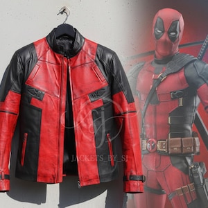 May include: A black and red leather jacket with a full-length zipper, hanging on a black hanger. The jacket has a design with black panels and red accents. The image also features a Deadpool character in the background.
